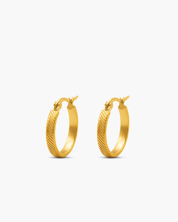 Gold hoop earrings on a white background