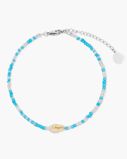 Beaded anklet with blue and white beads on a white background