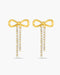 Gold bow-shaped earrings with diamond accents on a white background