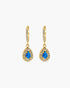 Gold earrings with blue gemstones on a white background