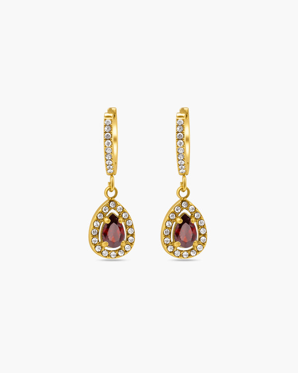 Gold earrings with gemstones on a white background