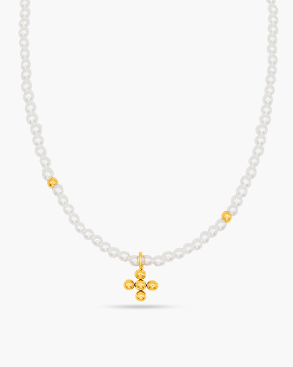 Necklace with white beads and a gold cross pendant on a white background
