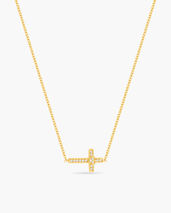 Gold necklace with a cross pendant on a white background