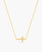 Gold necklace with a cross pendant on a white background