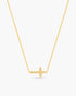 Gold necklace with a cross pendant on a white background