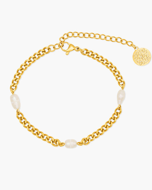 Gold chain bracelet with pearls on a white background