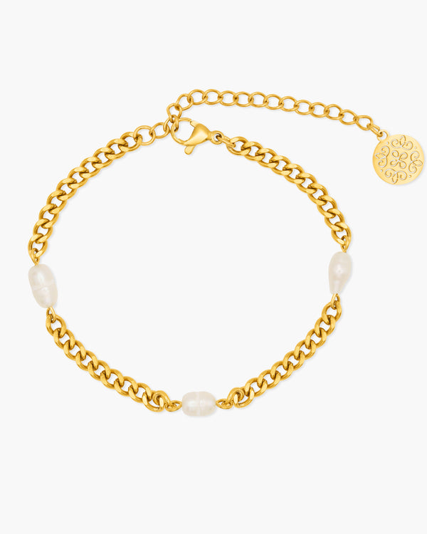 Gold chain bracelet with pearls on a white background
