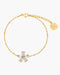 Gold bracelet with a floral clasp on a white background