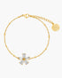 Gold bracelet with a floral clasp on a white background