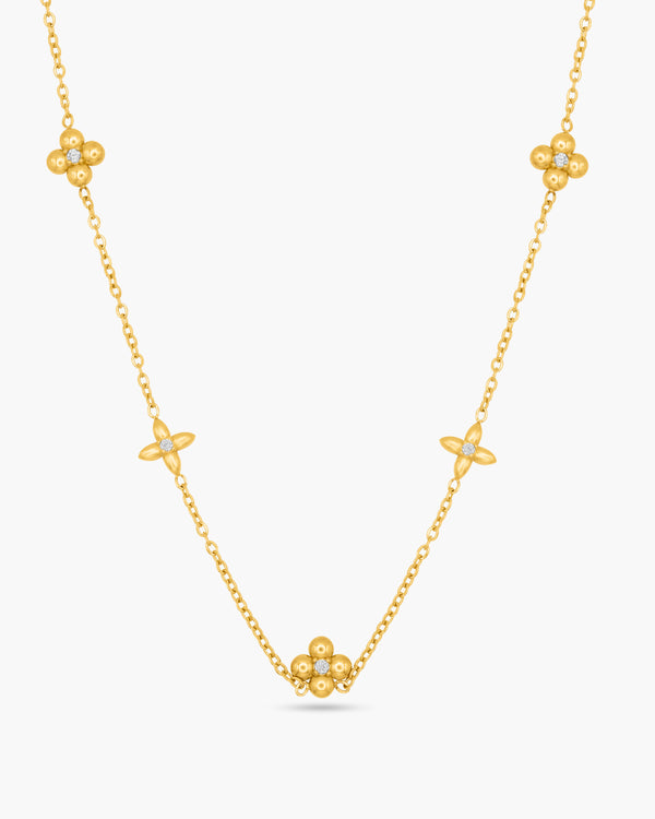A gold necklace against a white background