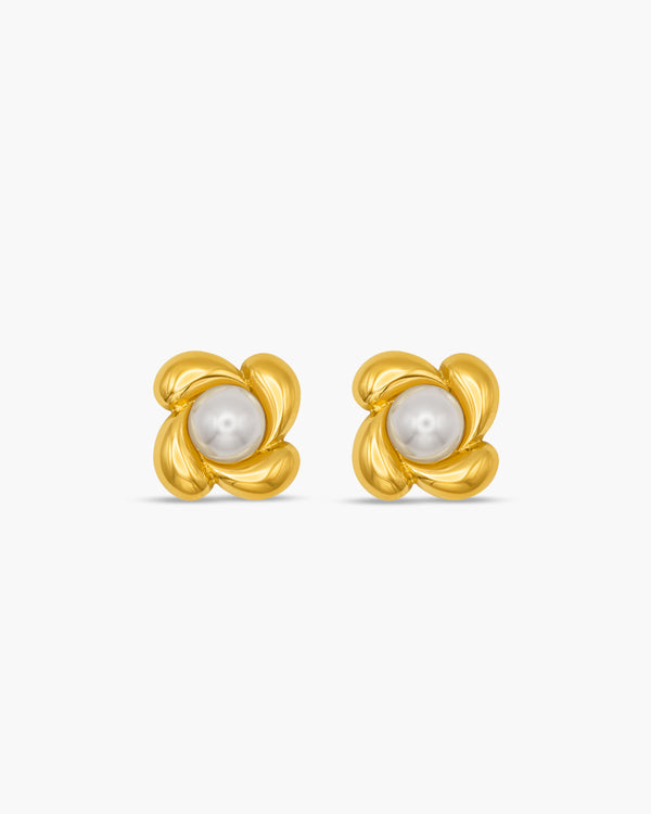 Pair of gold earrings with pearl centers on a white background
