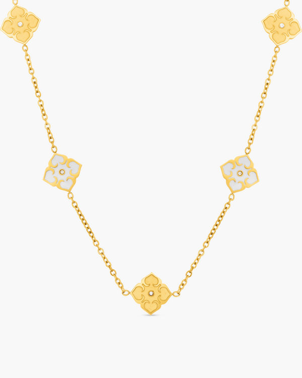 Gold necklace with floral pendants on a white background