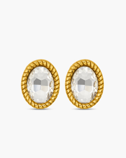 Gold earrings with clear gemstones on a white background