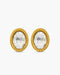 Gold earrings with clear gemstones on a white background