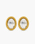 Gold earrings with clear gemstones on a white background