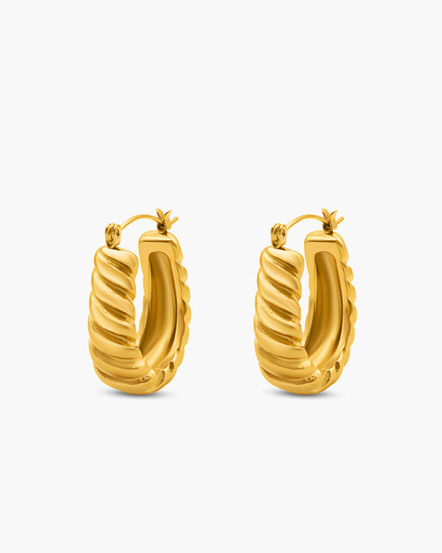 Gold hoop earrings on a white background