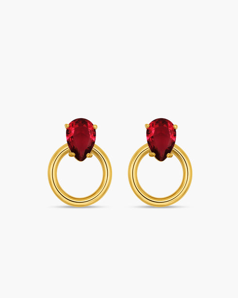 Gold hoop earrings with red gemstones on a white background