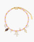 Anklet with pink beads, gold accents, and starfish charm on a white background