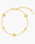 Gold bracelet with clover-shaped charms on a white background