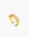Gold ring with leaf design on a white background