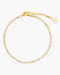 Gold anklet with clear stones on a white background
