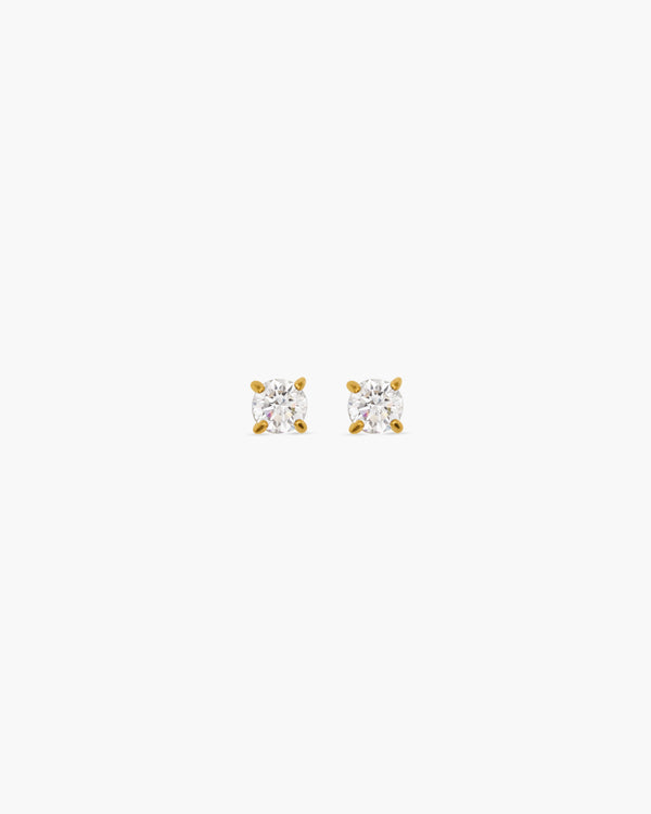 Pair of diamond stud earrings on a white background