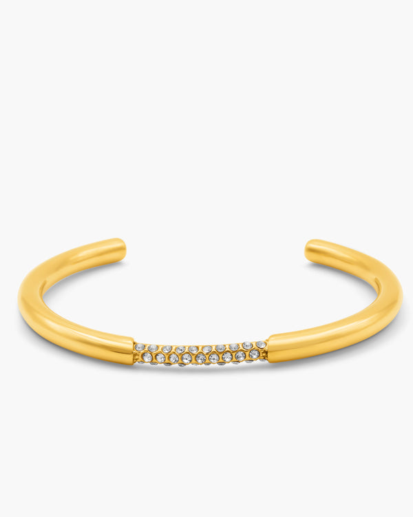 Gold bangle with small stones on a white background