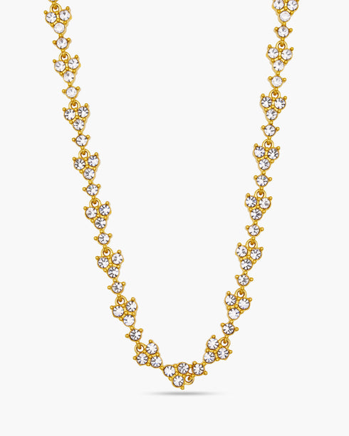 Gold necklace with clear stones on a white background