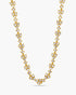 Gold necklace with clear stones on a white background