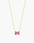 Gold necklace with a pink gemstone on a white background
