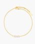 Gold anklet with three pearls on a white background