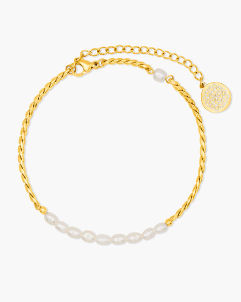 Gold anklet with pearl accents on a white background