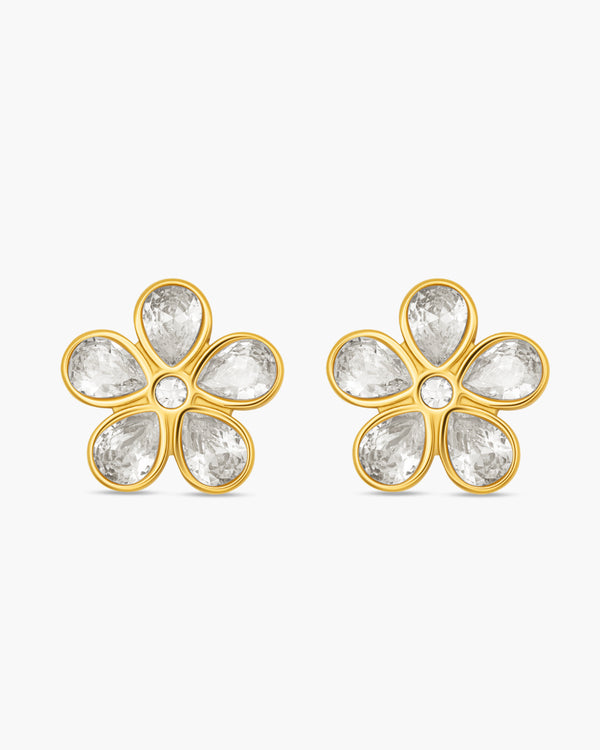 Gold flower-shaped earrings with clear gemstones on a white background