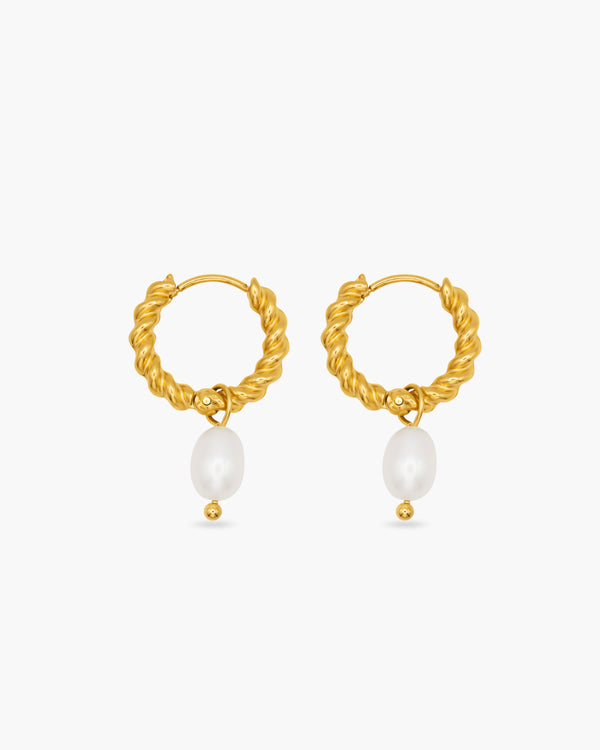 Gold hoop earrings with pearl drops on a white background