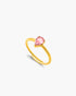 Gold ring with a pink gemstone on a white background