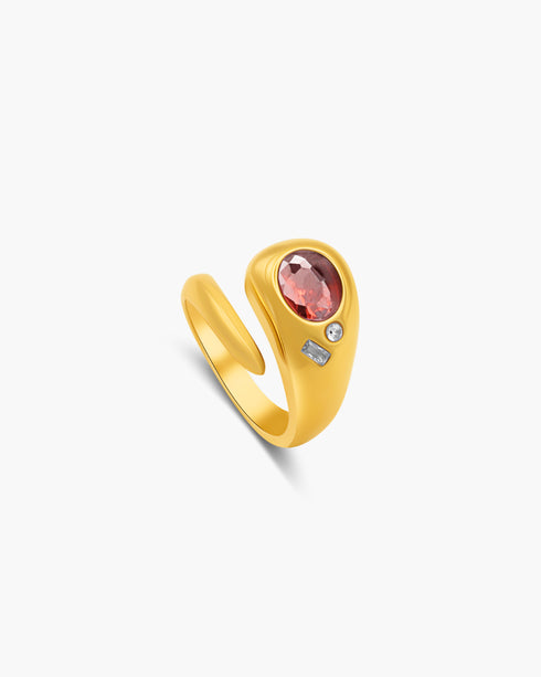 Gold ring with a red gemstone on a white background