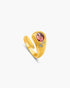 Gold ring with a red gemstone on a white background