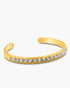 Gold bracelet with crystal stones on a white background