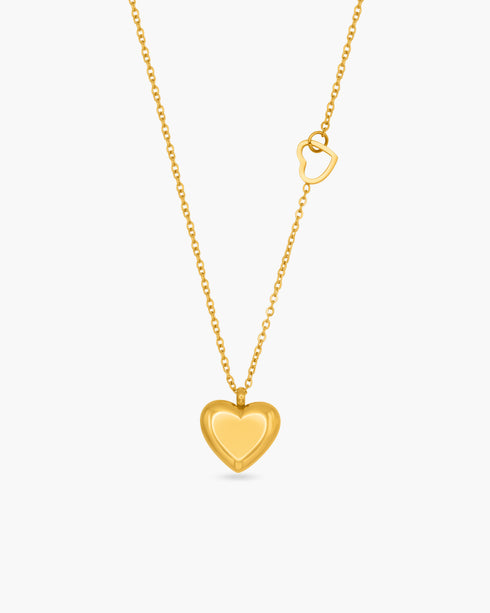 Gold heart-shaped pendant necklace on a white background