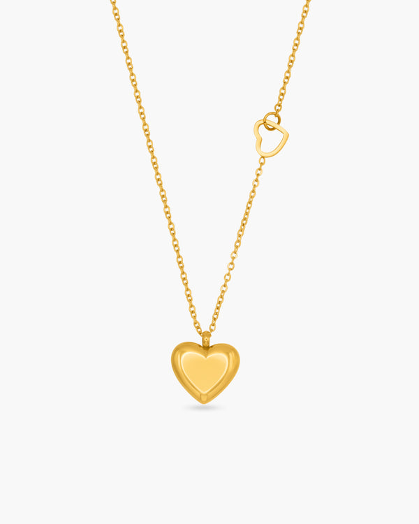 Gold heart-shaped pendant necklace on a white background