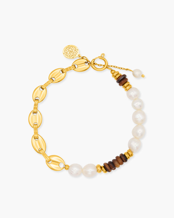 Gold bracelet with pearls and wooden beads on a white background