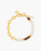 Gold bracelet with pearls and wooden beads on a white background