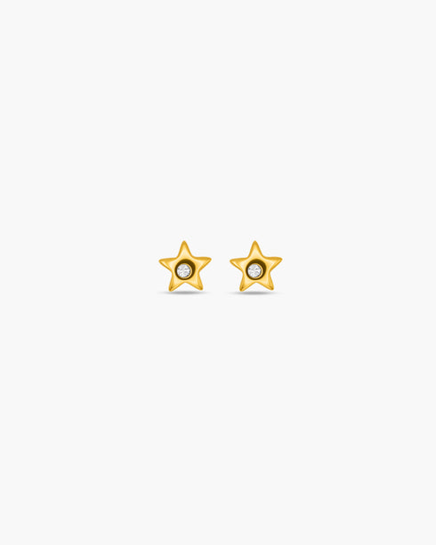 Gold star-shaped earrings on a white background