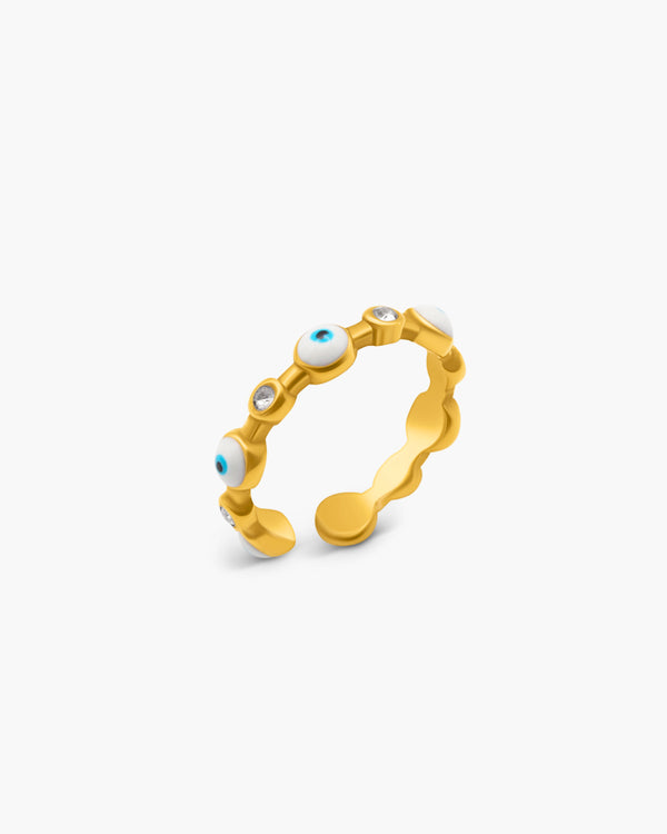 Gold ring with embedded stones on a white background