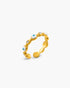 Gold ring with embedded stones on a white background
