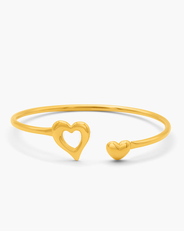 Gold bracelet with heart designs on a white background