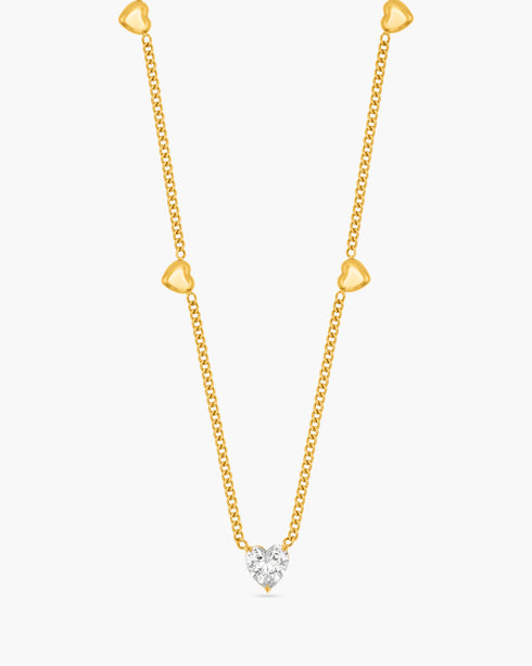 Gold necklace with a diamond pendant on a white background