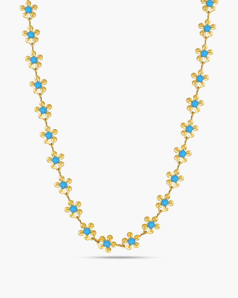 Gold necklace with blue stones on a white background