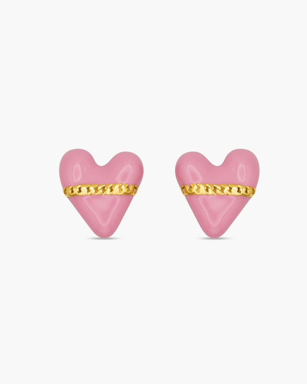 Pink heart-shaped earrings with gold bands on a white background