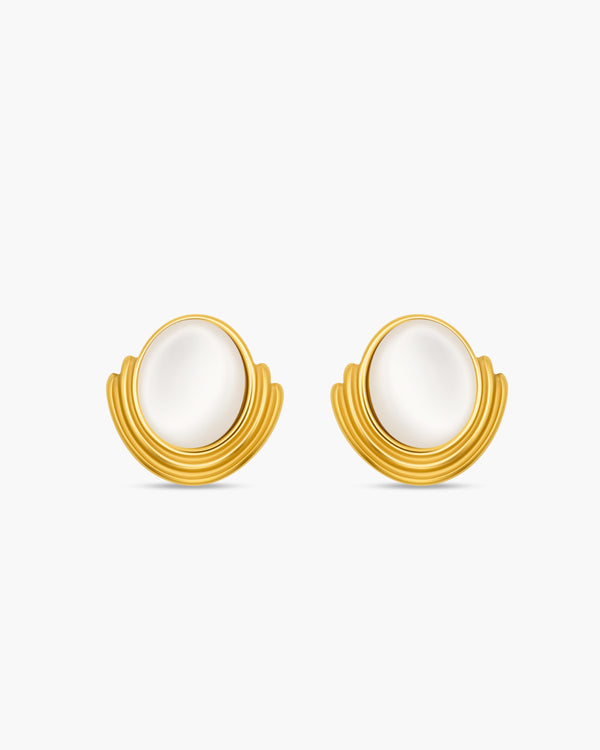 Gold earrings with white stones on a white background